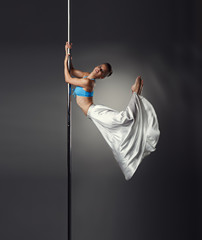 Image of beautiful female dancer posing on pylon