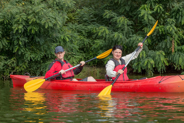 The couple goes kayaking on the river