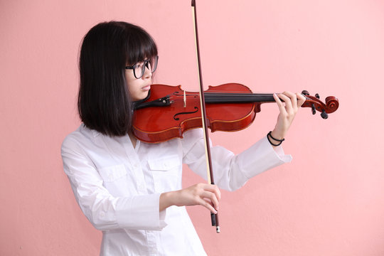Asian teen with violin glasses smile