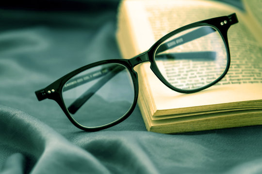 selective focus of reading Eyeglasses wiht opened book