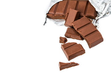 close up cracked chocolate bars in aluminum foil package on whit
