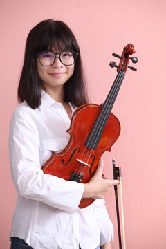 Asian teen with violin glasses smile