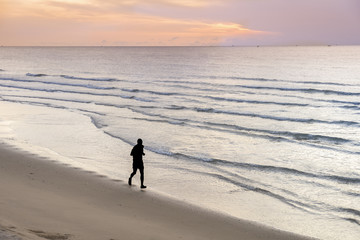 silhouette of man jogging on the beach