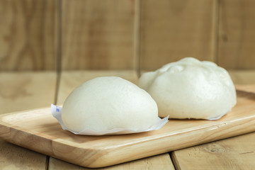 White Steamed buns on wooden tray