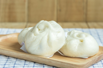 White Steamed buns on wooden tray