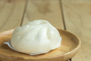 Fototapeta na wymiar White Steamed buns on wooden tray