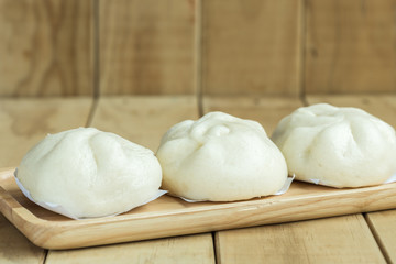 White Steamed buns on wooden tray