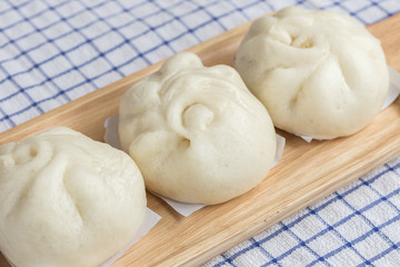 White Steamed buns on wooden tray
