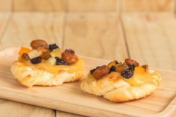 Danish custard with mixed dried fruit on wooden dish