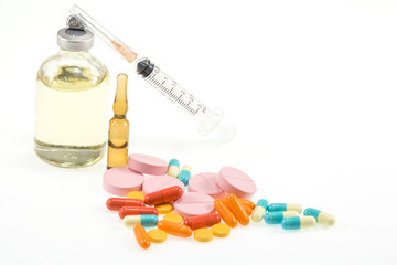 various medicines, pills and syringes on a white background