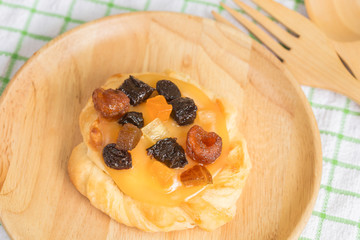 Danish custard with mixed dried fruit on wooden dish