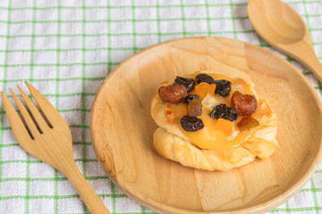 Danish custard with mixed dried fruit on wooden dish