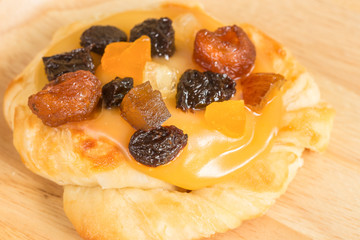 Danish custard with mixed dried fruit on wooden dish