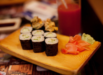 served maki rolls on wooden plate 