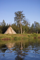 Fototapeta na wymiar Traditional hut to smoke fish on the river. Ponoy river, Kola Peninsula, Russia. 