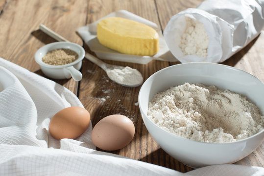  ingredients to make a cake on a wooden table