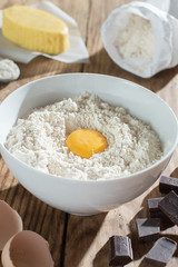 ingredients to make a cake on a wooden table