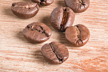 Macro photo of coffee beans on wooden table