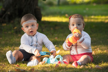 Babys, less than a year old, playing with  toys 