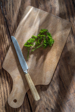 closeup, knife, parsley on a wooden board