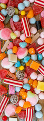 variety of candies on a wooden background 