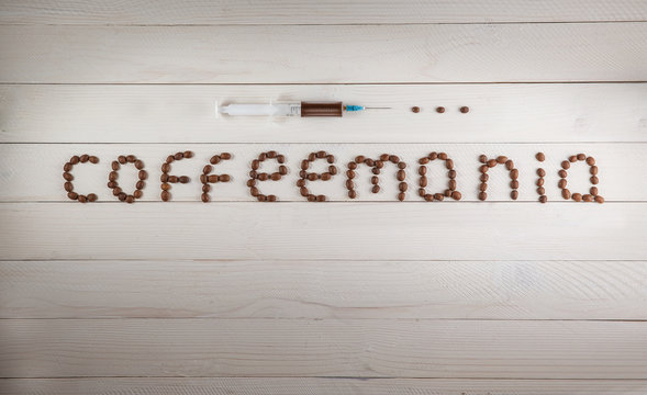 Fototapeta syringe and inscription Coffeemania coffee made from coffee bean