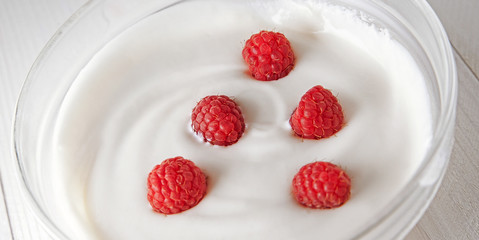 Raspberry in a glass of yogurt