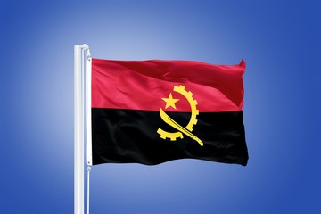 Flag of Angola flying against a blue sky