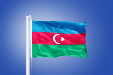 Flag of Azerbaijan flying against a blue sky