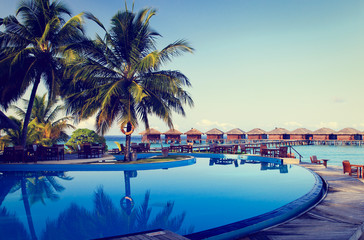 Tropical resort swimming pool and cafe bar - obrazy, fototapety, plakaty
