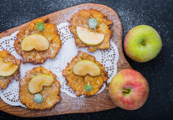 Pancakes with apples sprinkled with icing sugar