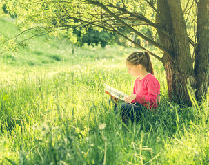 Cute little girl read the book