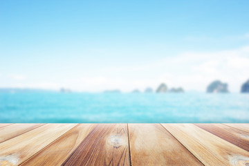 Close up wooden table with seascape blurred background