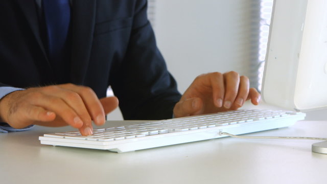 Businessman typing on his computer