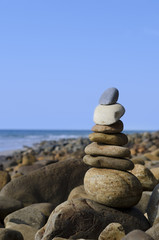 Fototapeta na wymiar Stacked up stones by beach