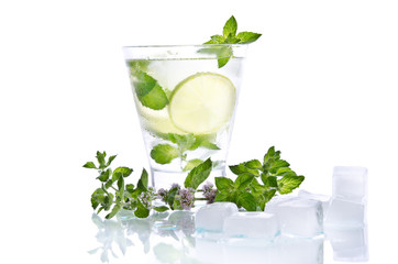 Glass of lemonade with lime and mint  on white background