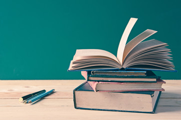 A pile of books on wooden table