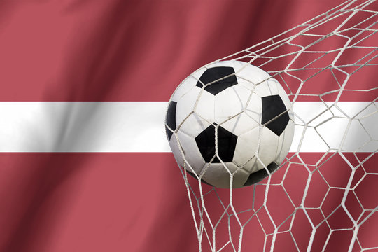 Latvia flag and soccer ball, football in goal net