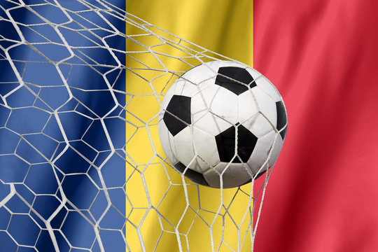 Romania waving flag and soccer ball in goal net