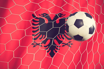 Albania flag and soccer ball, football in goal net vintage color