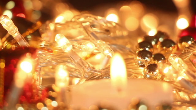 candle and christmas lights close-up out of focus
