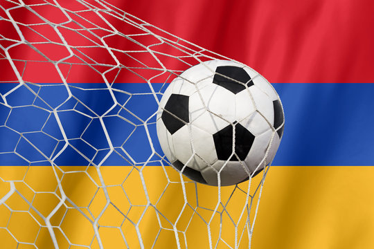 Armenia waving flag and soccer ball in goal net