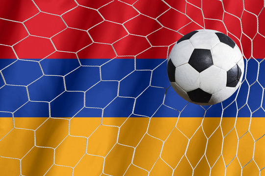 Armenia waving flag and soccer ball in goal net