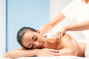 Young woman having spa back massage. - obrazy, fototapety, plakaty