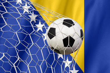 Bosnia waving flag and soccer ball in goal net