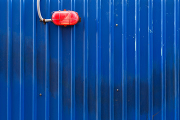 blue urban metal fence with red lamp