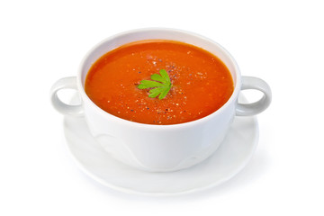 Soup tomato with parsley in white bowl on saucer