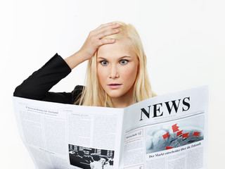 Woman is reading newspaper
