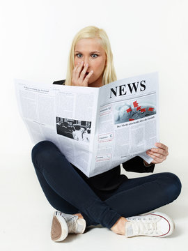 Woman is reading newspaper