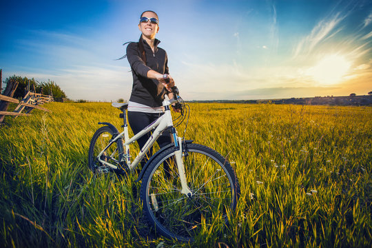 Woman is riding bicycle outside